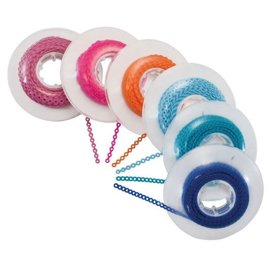 Colorful spools of thread with chains on a white background