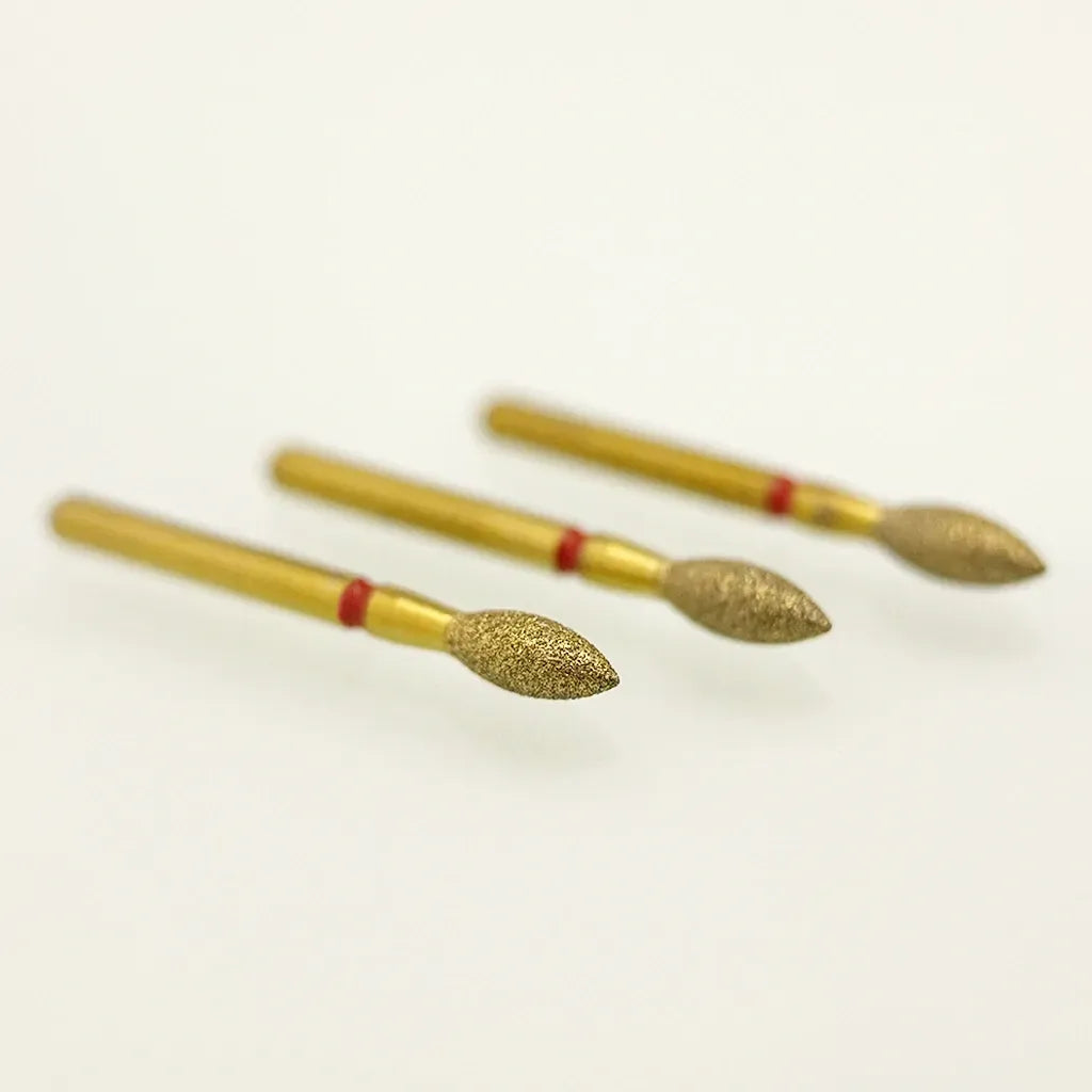 Three gold-colored nail drill bits with red bands on a white background