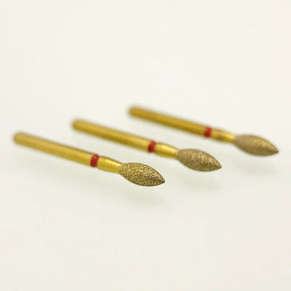 Three gold-colored nail drill bits with red bands on a white background