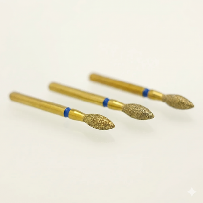 Three gold-colored nail drill bits with blue bands on a white background