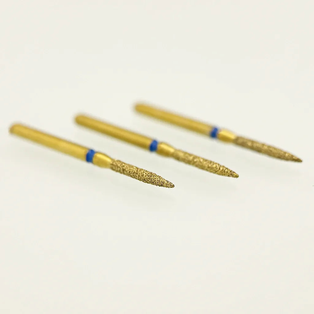 Three gold-colored nail drill bits with blue bands on a white background