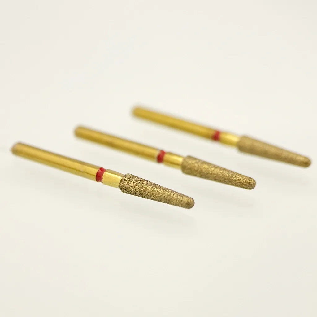 Three gold cylindrical objects with red bands on a white background