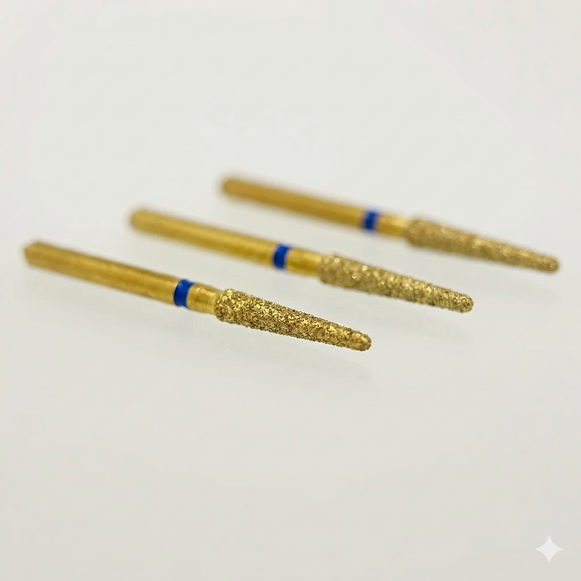 Three gold cylindrical objects with blue bands on a white background